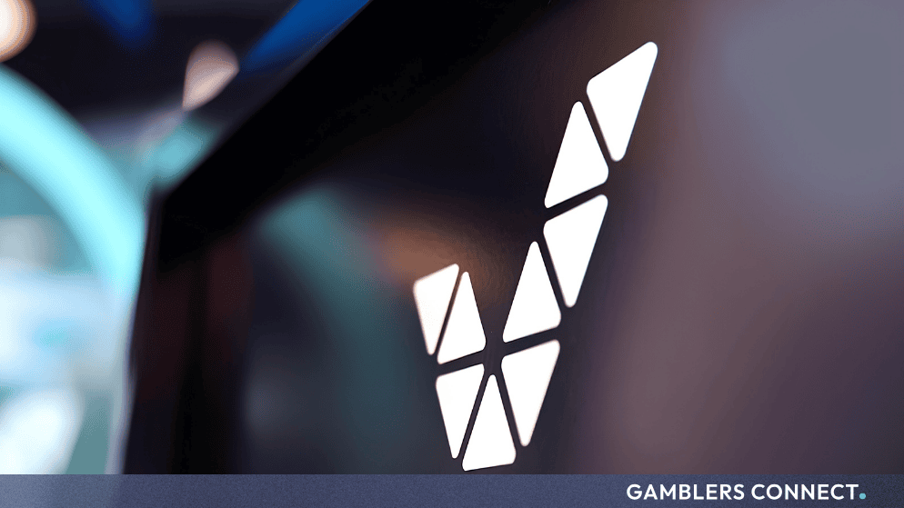 The stylized white Veikkaus V logo displayed on a dark corporate surface.