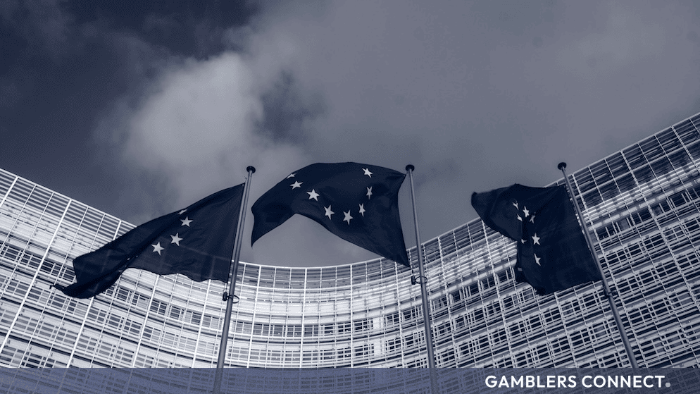 European Union flags flying against a dramatic sky representing AMLA regulatory technical standards