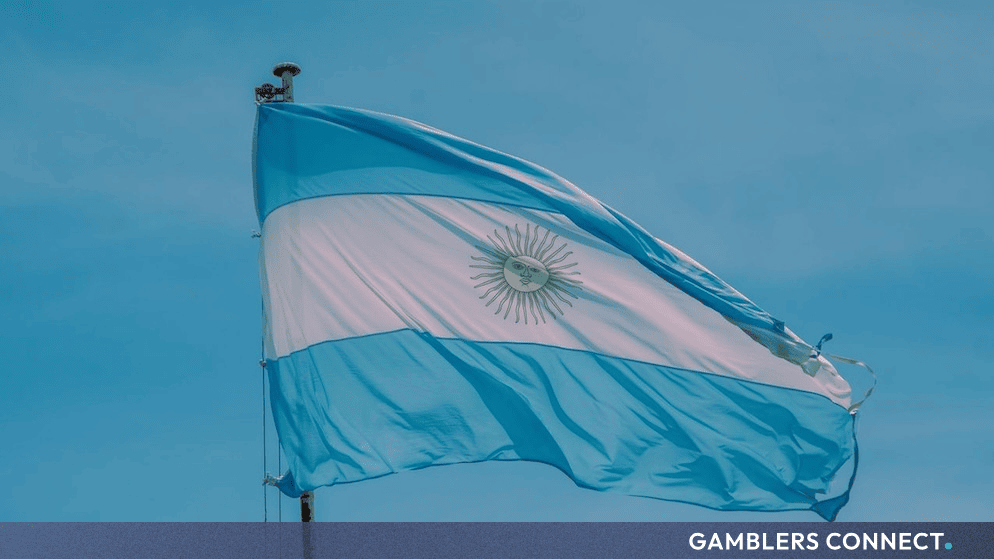 Argentine flag waving against a blue sky representing illegal gambling briefing in Buenos Aires