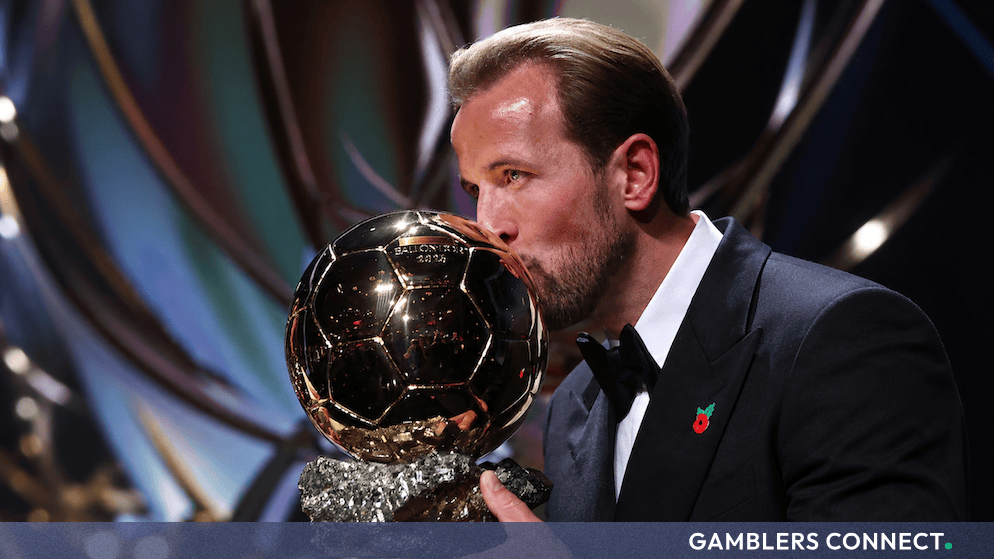 Harry Kane kissing the Golden Ballon d'Or trophy at the awards ceremony in London