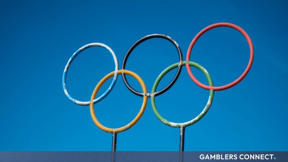 Olympic rings symbol against a bright blue sky representing sports integrity and regulatory oversight during the Youth Olympic Games