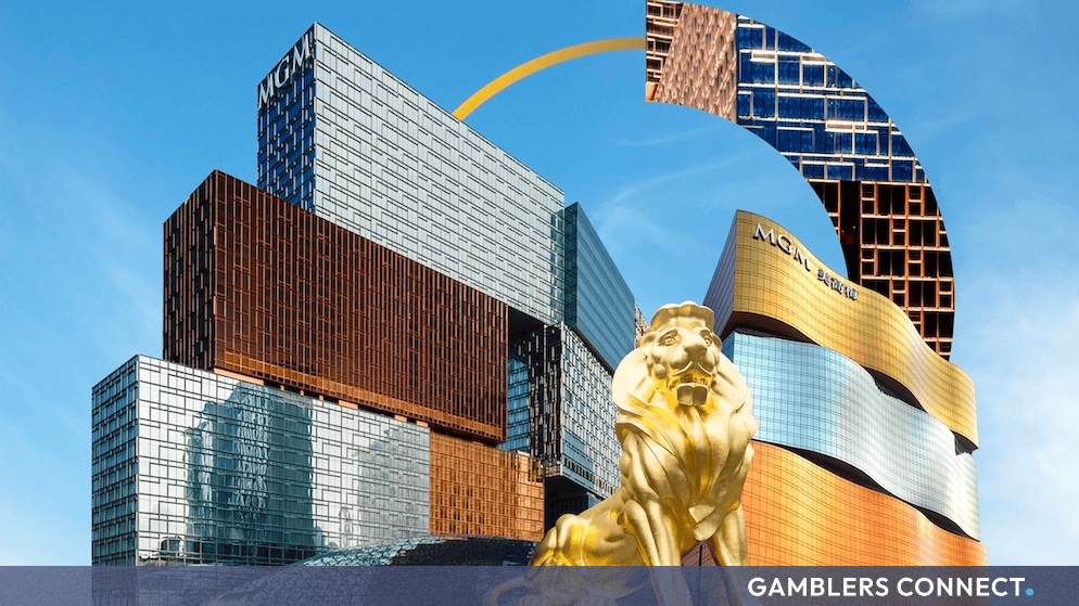 Golden golden lion statue outside MGM casino resort in Macau with modern architectural towers reflecting sunlight