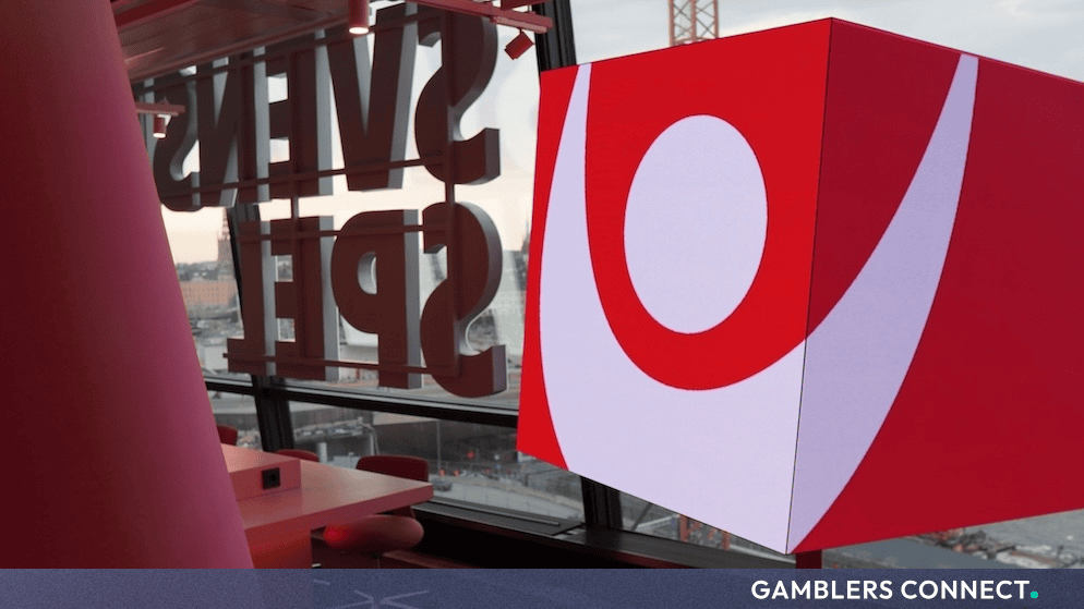 Svenska Spel branded red corporate cube and office interior representing Q3 financial results reporting