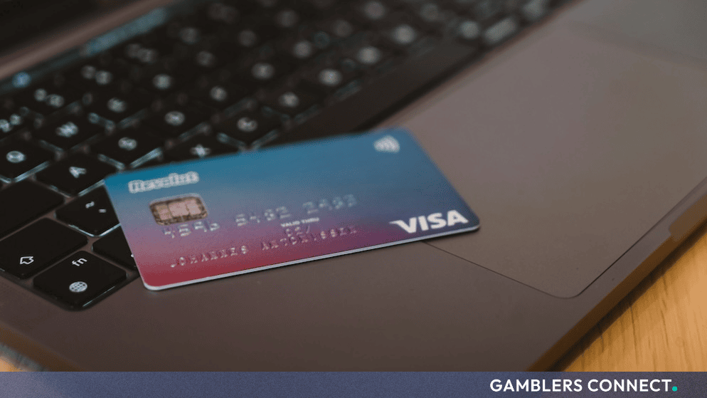 A Visa payment card resting on a laptop keyboard representing digital payment networks and blockchain settlement infrastructure